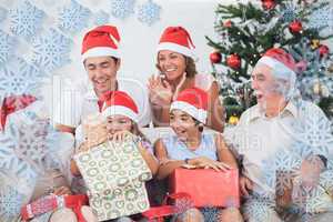 Composite image of little girl opening christmas present