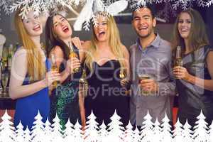Composite image of laughing friends holding beers posing