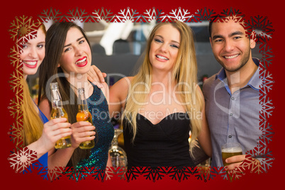 Portrait of smiling friends drinking beers