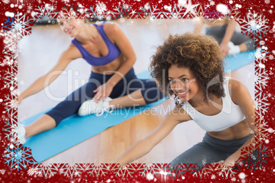 People doing stretching exercises in fitness studio