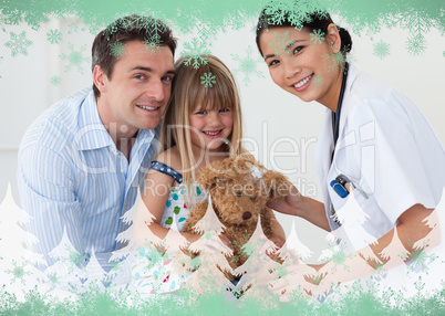 Portrait of a doctor and happy little girl examing a teddy bear