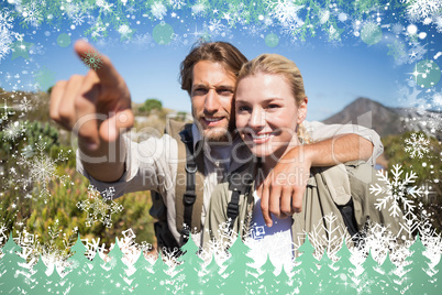 Happy hiking couple walking on mountain terrain