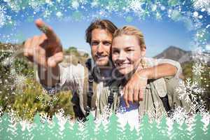 Happy hiking couple walking on mountain terrain