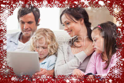 Composite image of serene family using a notebook