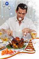 Attractive man eating turkey in christmas dinner