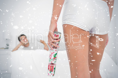 Sexy woman bringing christmas cracker to her partner