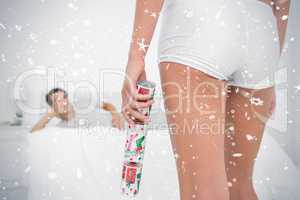 Sexy woman bringing christmas cracker to her partner