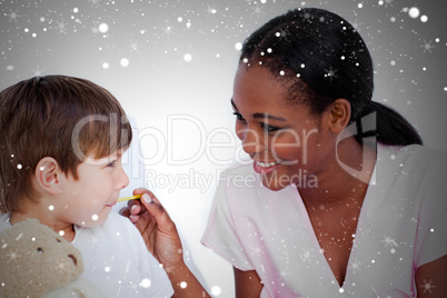 Composite image of smiling doctor taking childs temperature