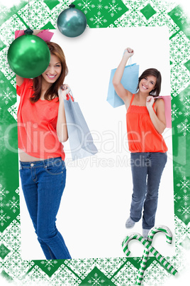 Teenage girl following her friend after shopping against a white background