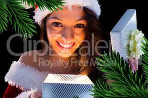 Pretty brunette in santa outfit opening gift