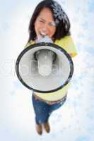 Composite image of close up of a megaphone holding by a young wo