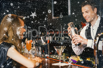 Handsome bartender serving cocktail to beautiful woman