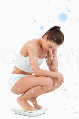 Composite image of portrait of a woman squatting on scales