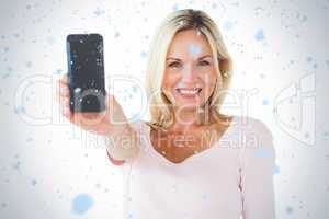 Happy blonde showing her smartphone