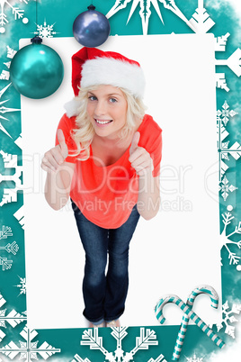 Fairhaired woman putting her thumbs up while wearing christmas clothes