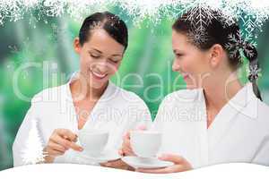 Beautiful friends in bathrobes drinking herbal tea
