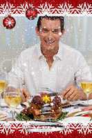 Smiling man eating turkey in christmas dinner