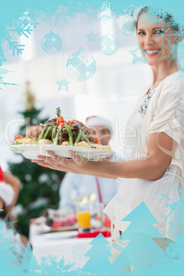 Attractive woman bringing roast chicken at a christmas dinner