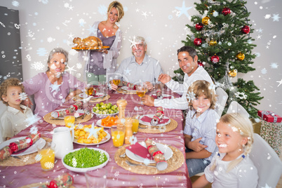 Composite image of mother bringing turkey to dinner table