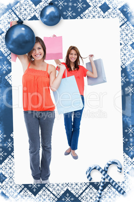 Smiling teenagers holding purchase bags in the air