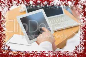 Doctors using laptop and digital tablet in meeting