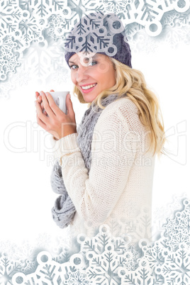 Pretty blonde in winter fashion holding mug