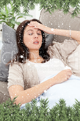 Sick woman lying on the sofa and touching her forehead