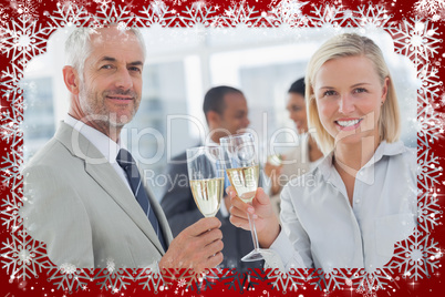 Business team celebrating with champagne and looking at camera