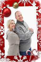 Composite image of happy mature couple in winter clothes