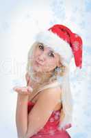Woman wearing santa hat as she blows kiss