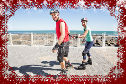 Fit mature couple rollerblading on the pier