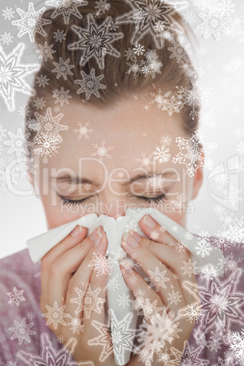 Composite image of woman blowing nose