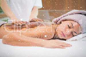 Attractive woman receiving chocolate back mask at spa center