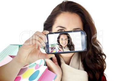 Composite image of hand holding smartphone showing