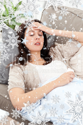 Sick woman lying on the sofa and touching her forehead