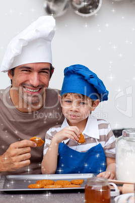 Father and son eating biscuits in the kitchen