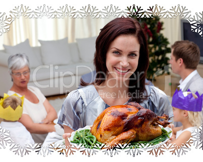 Woman showing christmas turkey for family dinner