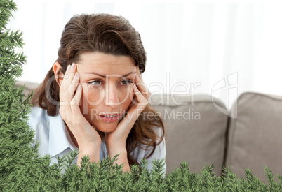 Tired businesswoman having a headache on the sofa
