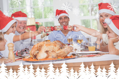 Composite image of siblings pulling a christmas cracker