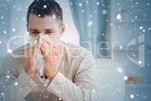 Composite image of man blowing his nose