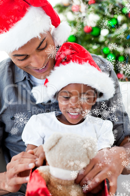 Composite image of happy father and daughter playing with christ