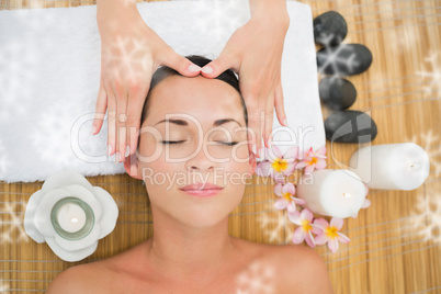 Smiling brunette enjoying a head massage