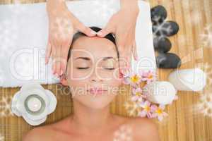 Smiling brunette enjoying a head massage