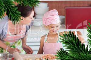 Cheerful mother and her daughter baking in a kitchen