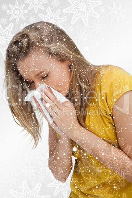 Close up of a blond young woman blowing