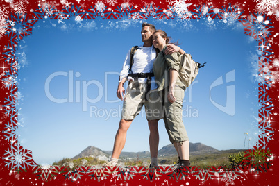 Hiking couple looking out over mountain terrain