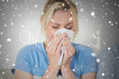 Closeup of a young woman suffering from cold