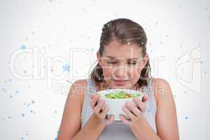 Composite image of woman smelling a salad