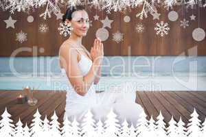 Content brunette in white sitting in lotus pose smiling at camera