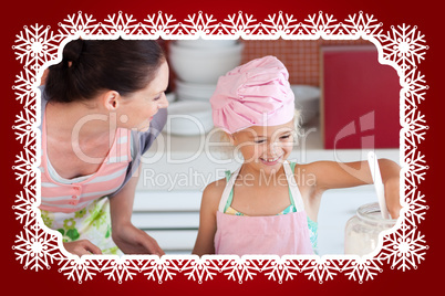 Cheerful mother and her daughter baking in a kitchen